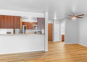 Thumbnail 5 of 25 - A kitchen with wooden cabinets and a white countertop.