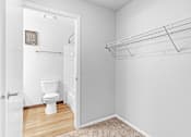 Thumbnail 11 of 25 - A white bathroom with a toilet and a shelf.