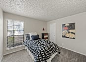 Thumbnail 9 of 38 - Bedroom with polka dot bedding and window at Parks on the Green Apartments, Temple