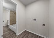 Thumbnail 11 of 38 - Laundry room with bathroom access and hookups at Parks on the Green Apartments, Texas, 76504