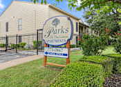 Thumbnail 20 of 38 - Property entrance sign directing to leasing office at Parks on the Green Apartments, Temple, TX 76504