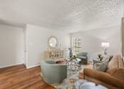 Thumbnail 36 of 38 - Living room with wood style flooring and decorative mirror at Parks on the Green Apartments, Texas