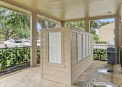 Thumbnail 24 of 38 - Covered mailbox area with package lockers at Parks on the Green Apartments, Temple, TX 76504