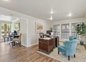 Thumbnail 32 of 38 - Office space with desk and blue accent chairs at Parks on the Green Apartments, Temple
