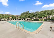 Thumbnail 27 of 38 - Swimming pool with handrail and lounge seating at Parks on the Green Apartments, Texas, 76504