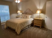 Thumbnail 19 of 22 - a bedroom with a bed and two nightstands and a window  at Summit Ridge Apartments, Texas, 76502