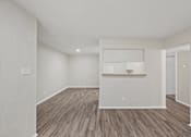 Thumbnail 7 of 38 - Open concept living area with white kitchen pass through at Parks on the Green Apartments, Temple, Texas