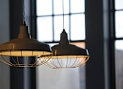 Thumbnail 8 of 14 - a couple of hanging lights in front of a window