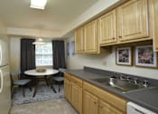Thumbnail 7 of 21 - Kitchen with eat-in dining  table and window at Village of Pine Run Apartments & Townhomes*, Maryland, 21244