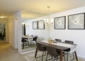 Thumbnail 5 of 21 - Dining room with a dining table and chairs and a wall with artwork at Village of Pine Run Apartments & Townhomes*, Maryland, 21244