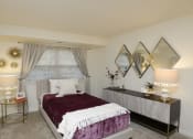 Thumbnail 14 of 21 - Bedroom with a bed and a dresser and a window at Village of Pine Run Apartments & Townhomes*, Maryland, 21244