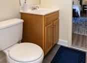Thumbnail 15 of 32 - A white toilet sits in a bathroom next to a bathtub