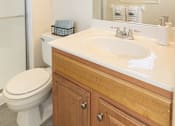 Thumbnail 27 of 36 - Bathroom with toilet and sink with cabinets