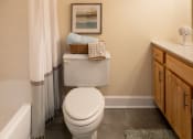 Thumbnail 15 of 28 - Bathroom with a toilet and a shower and a sink at Ivy Hall Apartments*, Towson, MD 21204.
