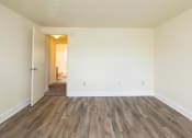 Thumbnail 19 of 23 - Bedroom with hardwood floors and white walls at The Orchards at Severn Townhomes*, Severn, 21144