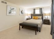 Thumbnail 15 of 31 - A bedroom with a large bed and two framed pictures on the wall.