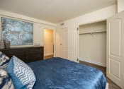 Thumbnail 13 of 28 - Bedroom with a large bed and a closet at Ivy Hall Apartments*, Towson, Maryland.