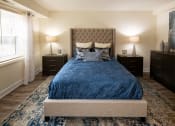 Thumbnail 10 of 28 - Bedroom with a bed and dressers at Ivy Hall Apartments*, Towson, MD 21204.