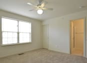 Thumbnail 8 of 16 - Bedroom with a ceiling fan and a window at The Pointe at Manorgreen Townhomes, Maryland, 21220