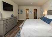 Thumbnail 16 of 27 - A bedroom with a large bed and a tv mounted on the wall.at Deer Park Apartments, Maryland, 21133