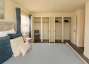 Thumbnail 7 of 12 - A bedroom with a bed, pillows, and a grey carpet at Security Park Apartments*, Maryland, 21244