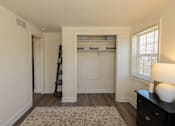 Thumbnail 11 of 36 - A room with a ladder and a dresser with a lamp on it.
