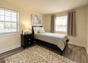 Thumbnail 10 of 36 - A bedroom with a bed, nightstand, and window