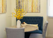 Thumbnail 12 of 19 - Dining room table with two chairs and a vase with flowers at Winston Apartments, Baltimore, Maryland