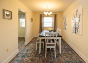 Thumbnail 4 of 23 - Dining room with a table and chairs at Rockdale Gardens Apartments in Windsor Mill, MD.