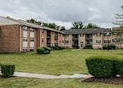Thumbnail 10 of 11 - A large grassy area in front of apartment buildings at Deer Park Apartments, Randallstown, 21133
