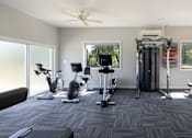 Thumbnail 21 of 28 - Gym with treadmills and other exercise equipment at Cromwell Valley Apartments, Towson