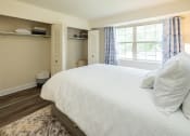 Thumbnail 14 of 29 - Guest bedroom with a bed and a window at Woodridge Apartments.