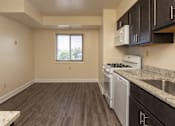 Thumbnail 10 of 16 - A kitchen with a stove, oven, and cabinets at Lawyers Hill Apartments, Elkridge, 21075
