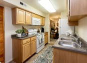 Thumbnail 4 of 31 - Large eat in kitchen with washer and dryer in unit at Spring Hill Apartments & Townhomes, Baltimore, MD