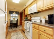 Thumbnail 5 of 31 - Large eat in kitchen with washer and dryer in unit at Spring Hill Apartments & Townhomes, Baltimore, MD 21234