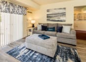 Thumbnail 3 of 32 - Living room with a gray couch at Seven Oaks Townhomes, Edgewood