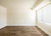 Thumbnail 15 of 23 - Empty room with white walls and a wooden floor  at The Orchards at Severn Townhomes*, Severn, MD 21144