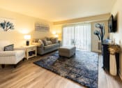 Thumbnail 2 of 29 - Living room with a couch, a chair, a rug, and décor in Randallstown, MD 21133.