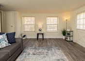 Thumbnail 5 of 36 - Living room with two windows and wood, vinyl flooring.