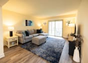 Thumbnail 2 of 23 - Living room with a couch at Rockdale Gardens Apartments*, Baltimore.