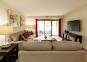 Thumbnail 8 of 28 - Living room with a couch and a tv at Ivy Hall Apartments*, Towson, MD 21204