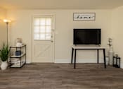 Thumbnail 31 of 36 - Living room with wood, laminate flooring and side entry door