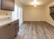 Thumbnail 5 of 22 - a kitchen and living room in an empty apartment at Carlson Woods Townhomes, Maryland