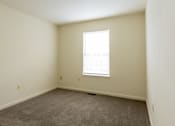 Thumbnail 14 of 22 - a bedroom with white walls and a window at Carlson Woods Townhomes, Baltimore, Maryland