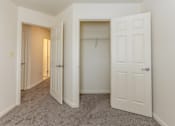 Thumbnail 20 of 22 - a bedroom with a closet and an open door at Carlson Woods Townhomes, Baltimore