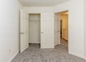 Thumbnail 12 of 22 - a bedroom with two closets and a carpeted floor at Carlson Woods Townhomes, Baltimore, MD