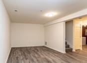 Thumbnail 10 of 22 - a living room with a hardwood floor and white walls at Carlson Woods Townhomes, Baltimore, Maryland