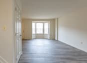 Thumbnail 6 of 22 - an empty room with white walls and a large window at Carlson Woods Townhomes, Baltimore, MD, 21244