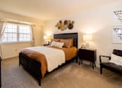 Thumbnail 10 of 21 - A bedroom with a large bed and a chair.