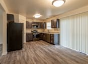 Thumbnail 3 of 22 - a kitchen with a refrigerator freezer and a stove top oven at Carlson Woods Townhomes, Baltimore, Maryland